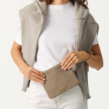 Model holding the Oyster Pouch 