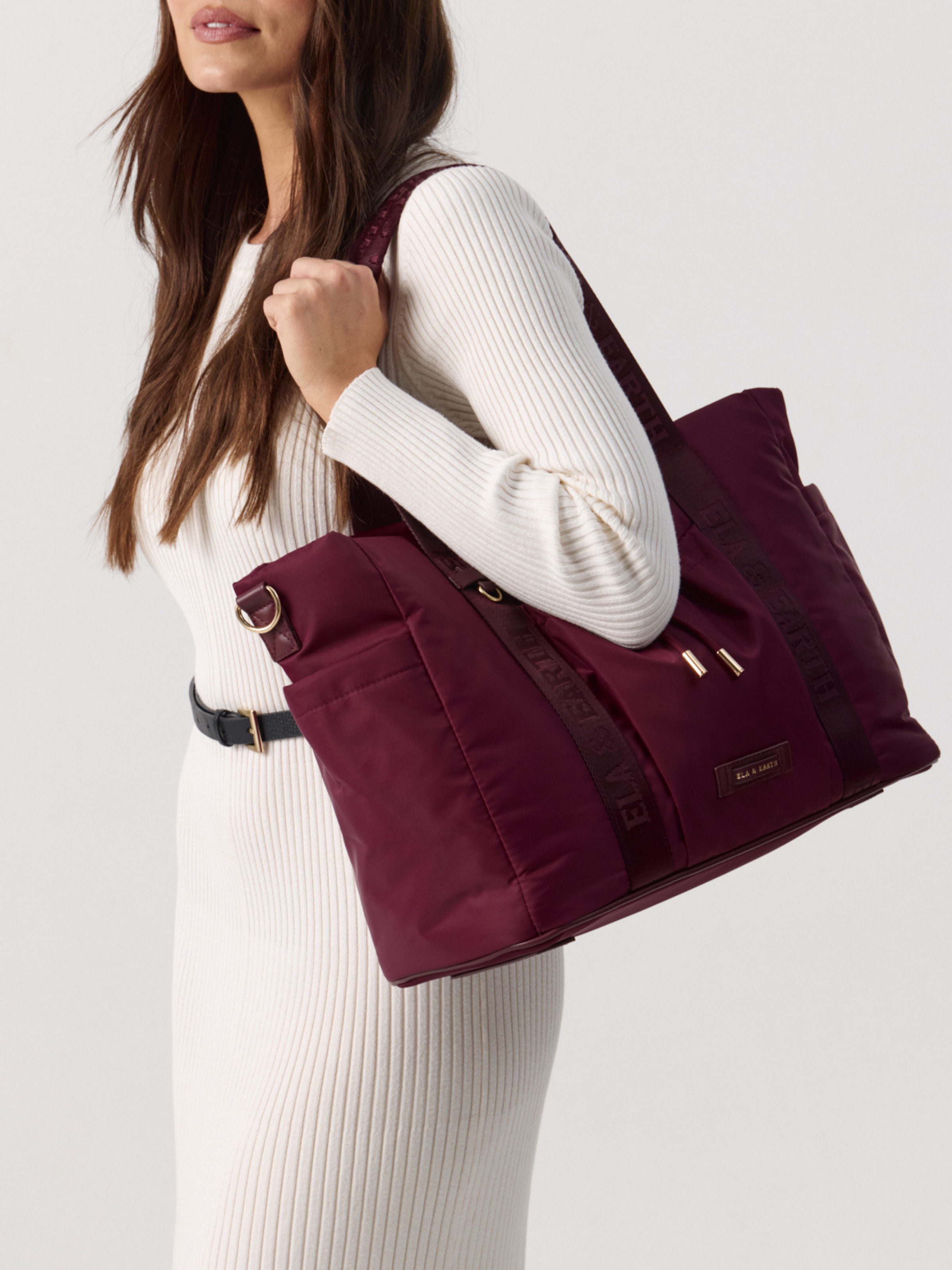 Model  holding a Shiraz Tote against a plain background