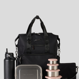 Black backpack with stainless steel containers and water bottle on a light gray background
