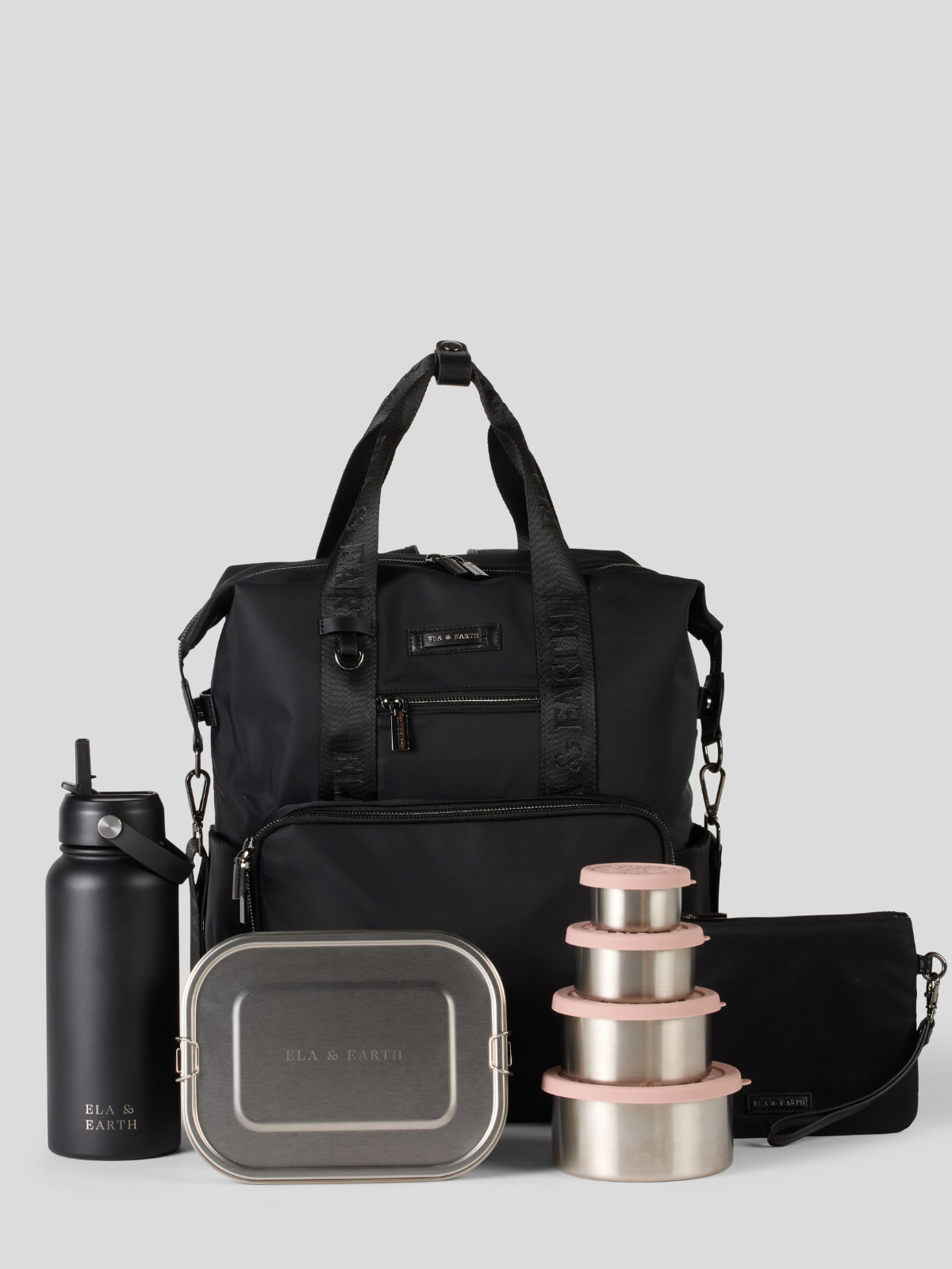 Black backpack with stainless steel containers and water bottle on a light gray background