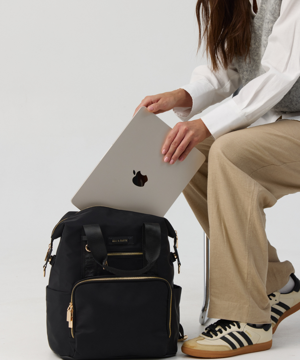 Model Holding the laptop inside the Large Backpack 