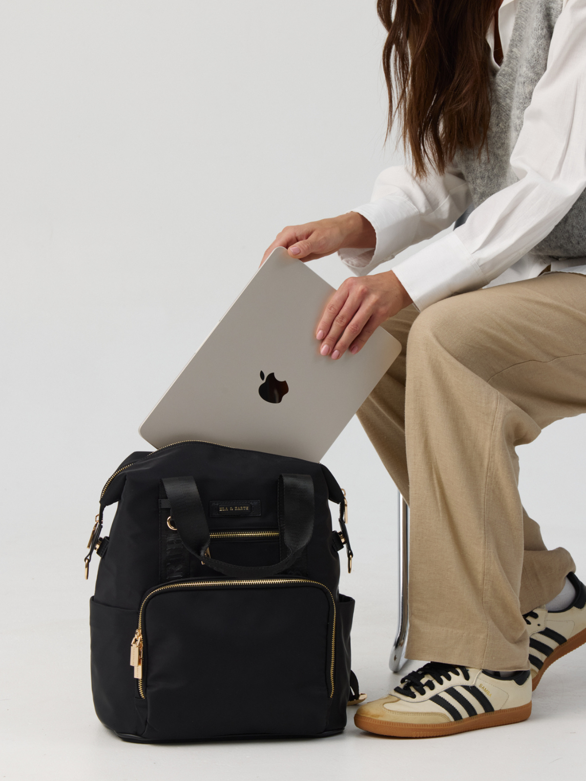 Model Holding the laptop inside the Large Backpack 