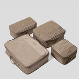 Four Oyster packing cubes of different sizes arranged on a light gray background.