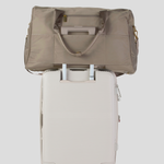 Oyster  Weekender Travel bag on top of a suit