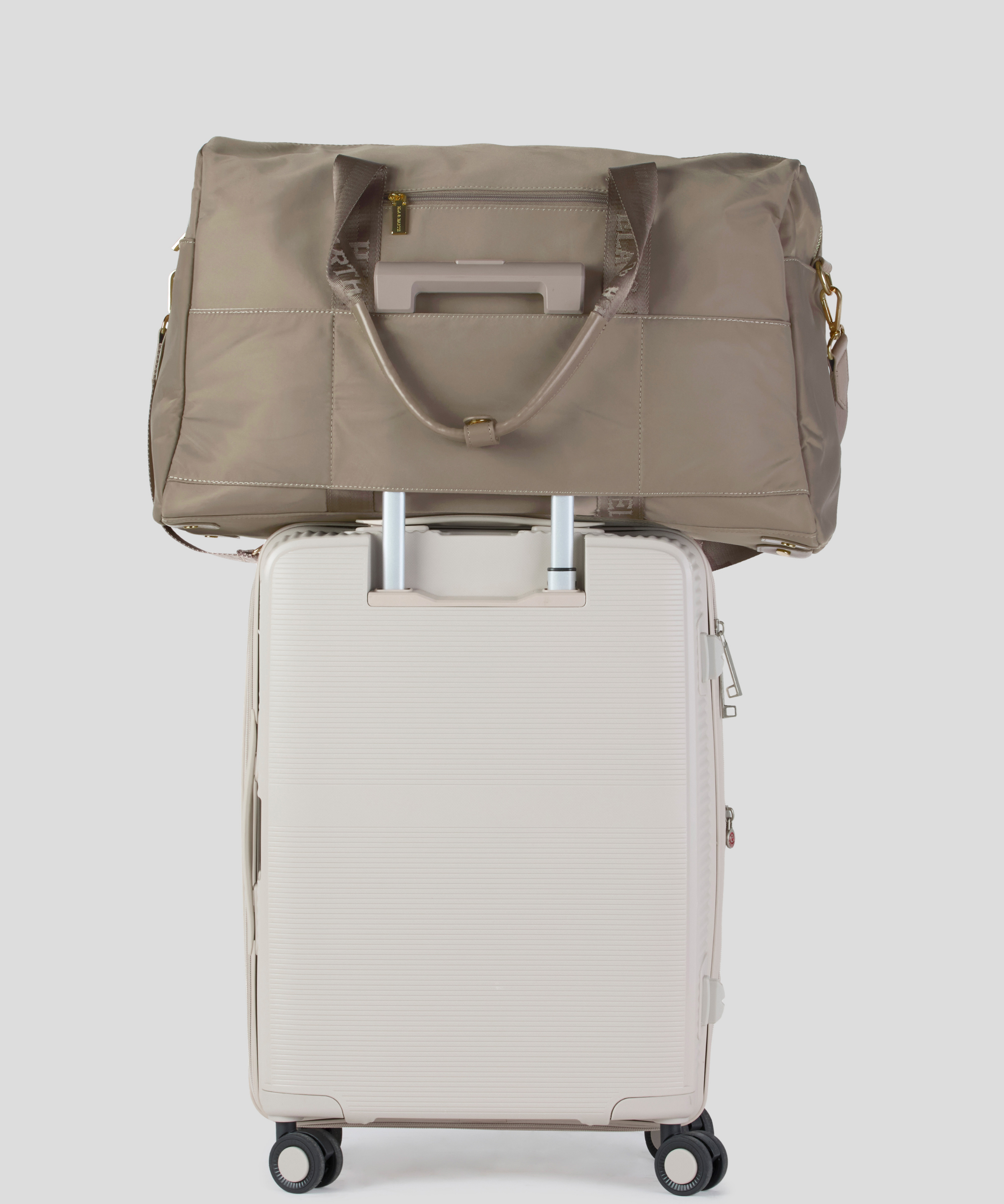 Oyster  Weekender Travel bag on top of a suit