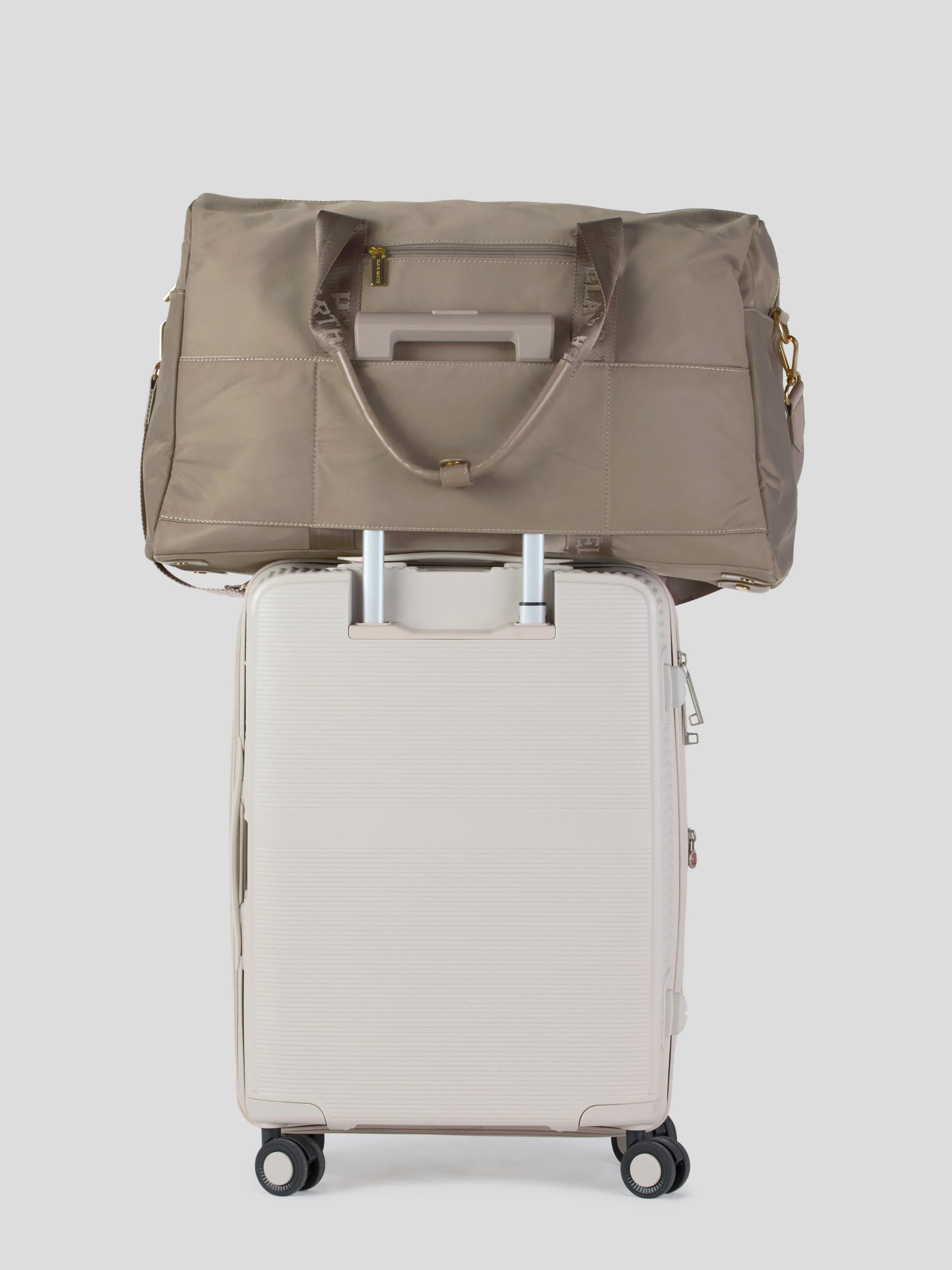 Oyster  Weekender Travel bag on top of a suit