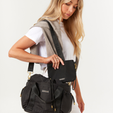 Model holding a Black Lunch bucket bag 